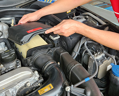 mechanic changing car air filter