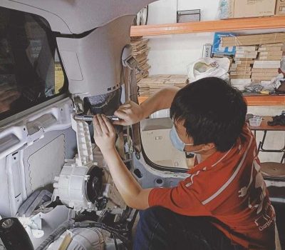 person repairing hybrid car